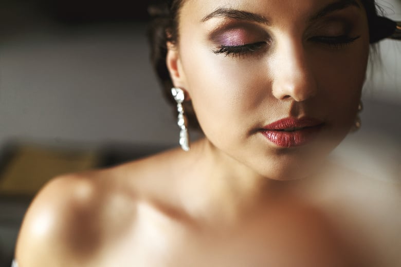 Stylist Putting on Makeup on Bride